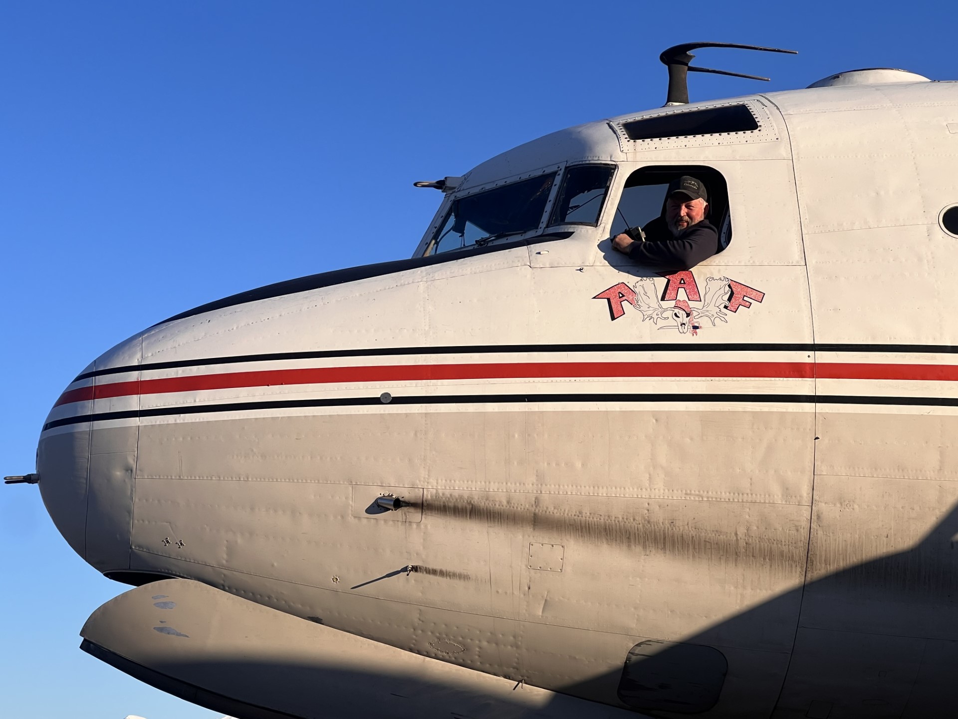 John in DC-4 cockpit window